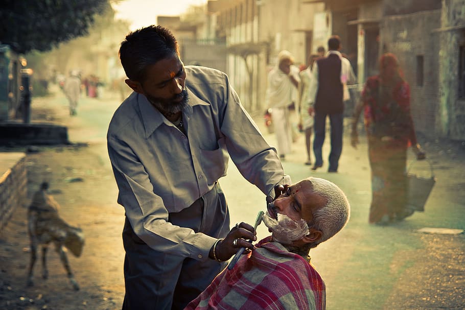 selective focus photography of man shaving beard, barber, vrindavan