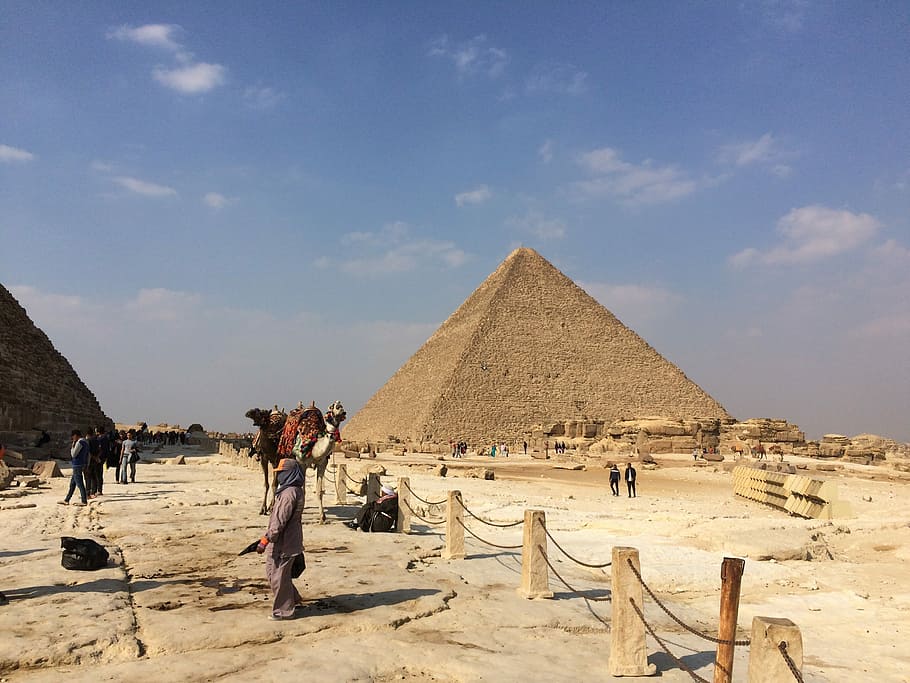 Egyptian Pyramid, person standing near pyramid of Giza at daytime HD wallpaper