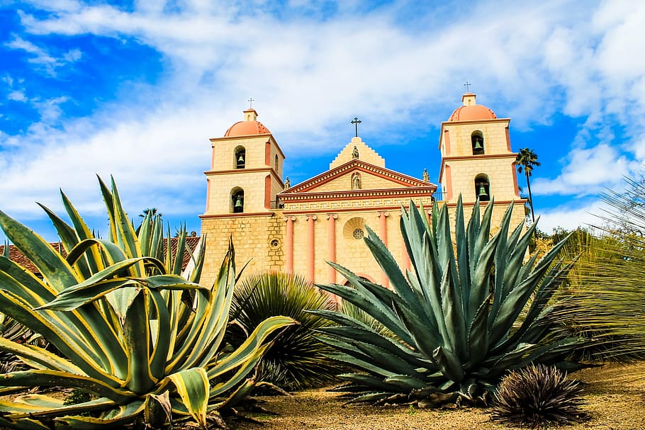 beige church surrounded with green leafed plants, usa, santa barbara