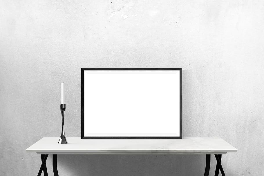 rectangular white board with black wooden frame on top of white wooden console table HD wallpaper