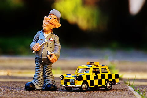 yellow and black Taxi toy beside mechanic man figure, funny HD wallpaper