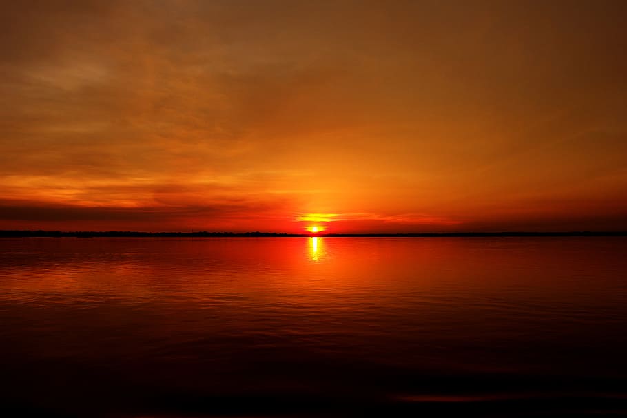 silhouette photography of body of water during golden hour HD wallpaper