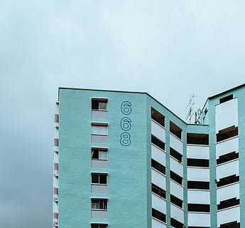 blue and white concrete building, teal and white 668 concrete high-rise building under cloudy sky during daytime HD wallpaper