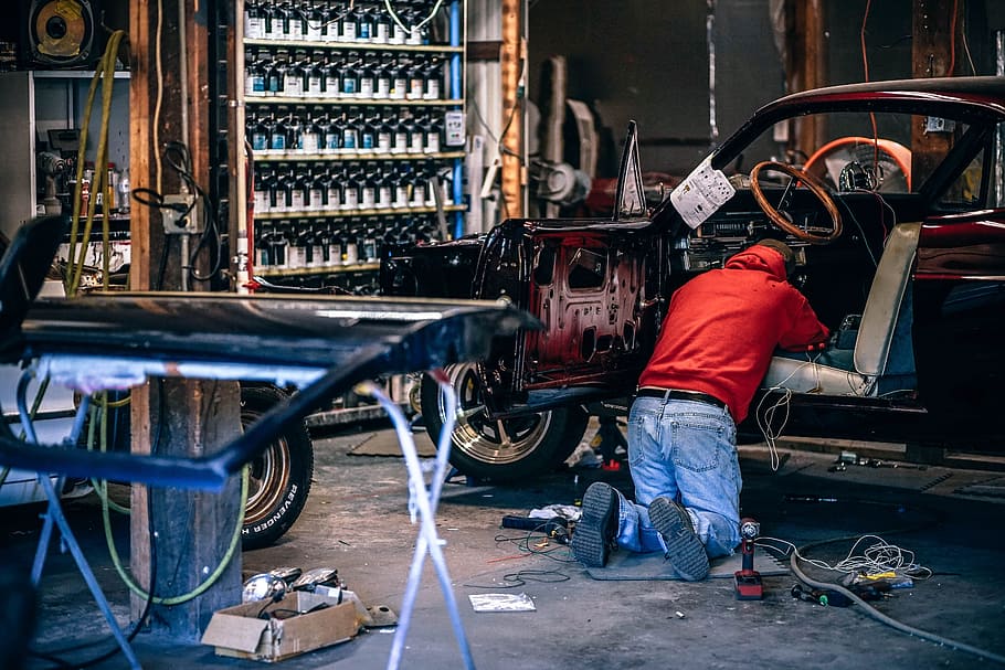 person fixing car, man repairing inside of car, Car Restoration