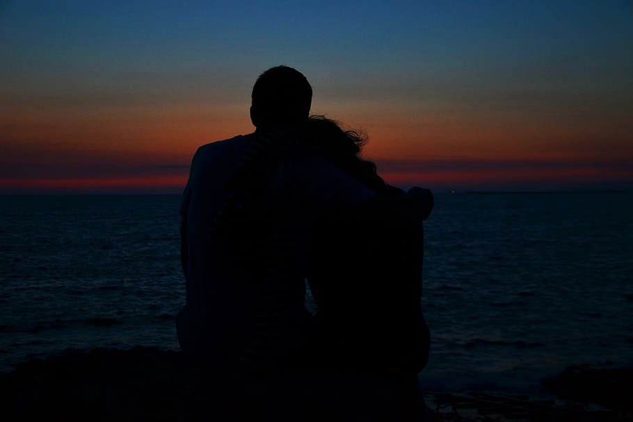 silhouette of man and woman during golden hour, sunset, pair