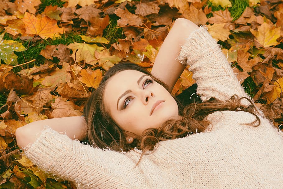 Woman in Sweater Laying on Dried Maple Leaves, autumn, autumn leaves