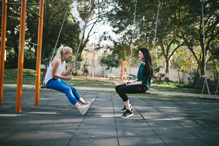 Hd Wallpaper Woman Sitting On Swing Two Women Seating On Swings Girls Females Wallpaper Flare