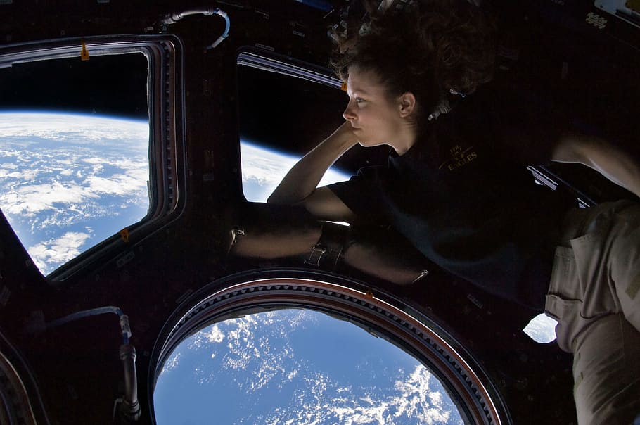 woman looking at the globe earth, international space station