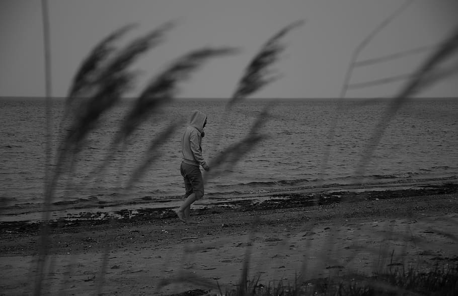 greyscale photo of person in hoodie walking in seashore, melancholy, HD wallpaper