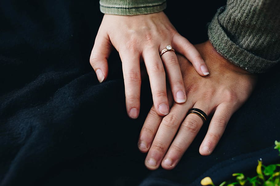 woman holding hand of man, man and woman wearing wedding rings HD wallpaper