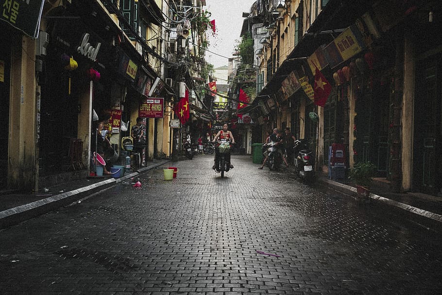 person riding motor scooter near building, person riding on a motorcycle during daytime, HD wallpaper