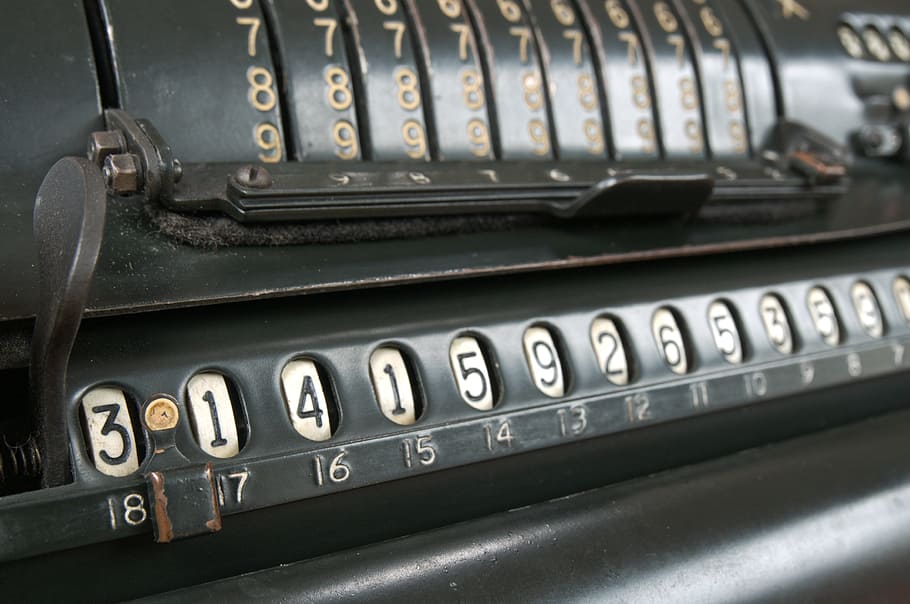 closeup photo of black metal tool, vintage, calculator, pi, calculation