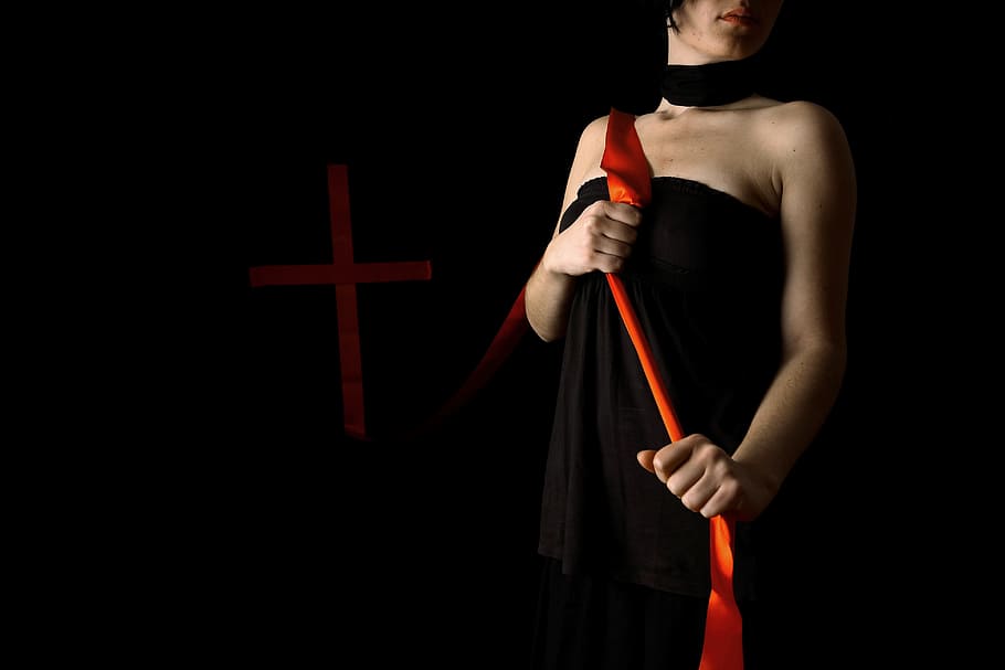 woman wearing black halter dress holding red lace lowlight photography