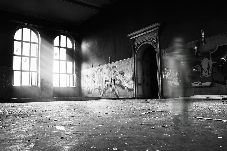 grayscale photo of person standing inside building, grayscale photo of room interior