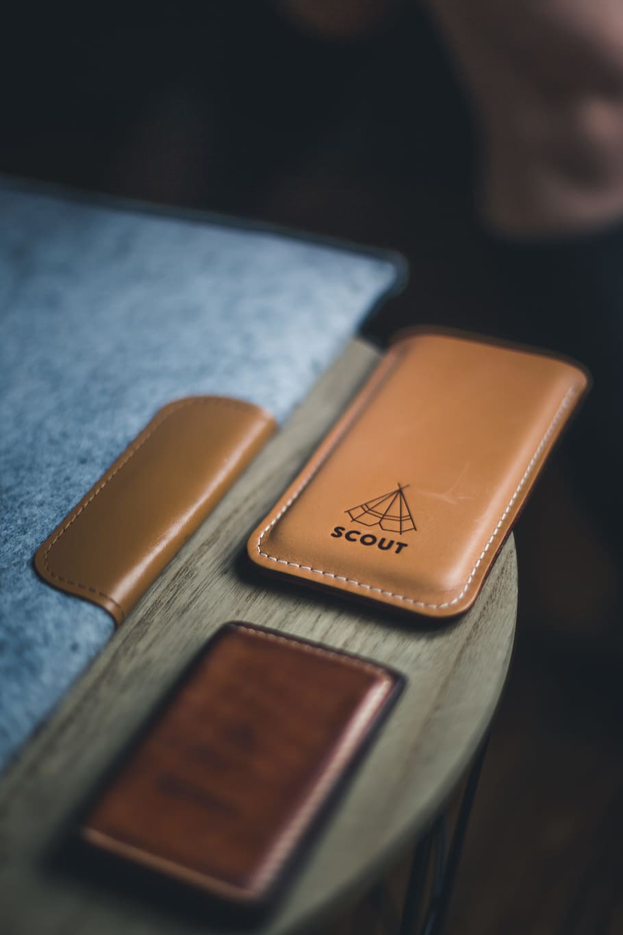 Leather laptop cover, wallet, and phone holder with a label that reads 