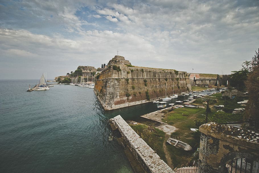 concrete structure beside body of water, brown concrete ruins on body of water under white cloudy sky HD wallpaper