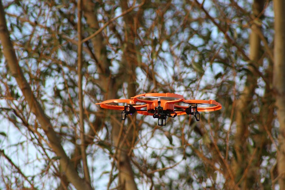 selective focus photo of orange and black drone at daytime HD wallpaper