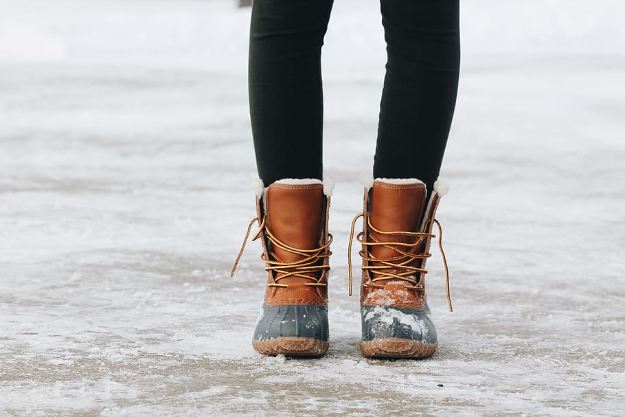 person standing on brown ground, person's wearing brown boots standing HD wallpaper