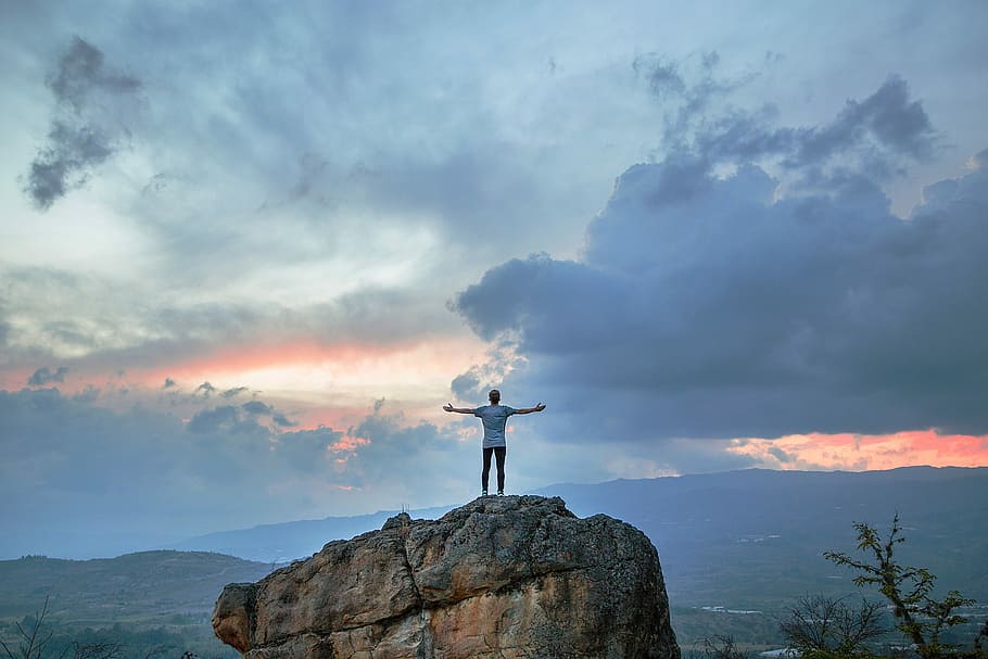 man in white shirt standing on brown rock, nature, sky, cloud - Sky HD wallpaper