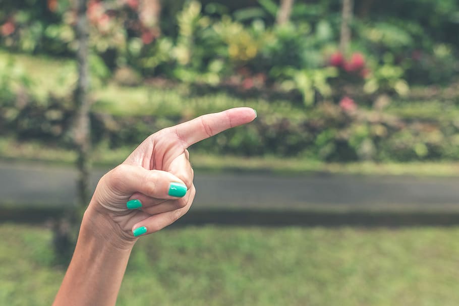 Woman finger on a blurred jungle background, woman finger pointing HD wallpaper