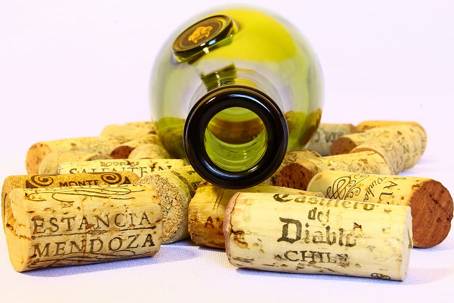 green wine bottle with assorted wine corks, stoppers, empty, used
