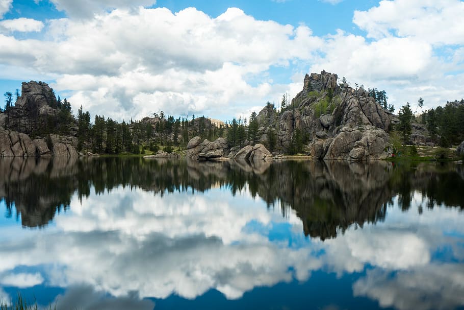 photography of body of water near mountain at daytime, panoramic photo of rock formation beside body of water HD wallpaper