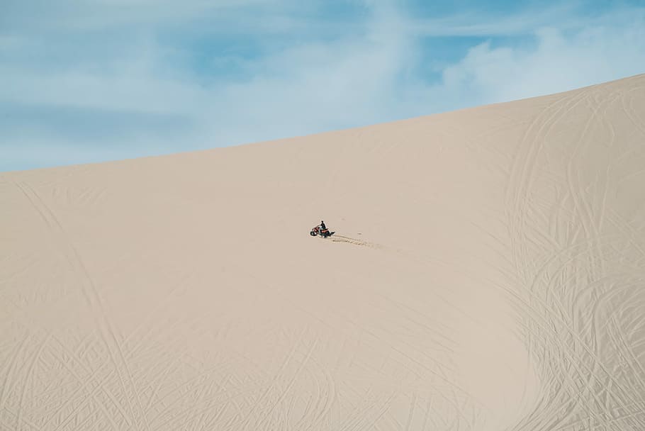 person riding motorcycle in the sand, in distant person in desert HD wallpaper