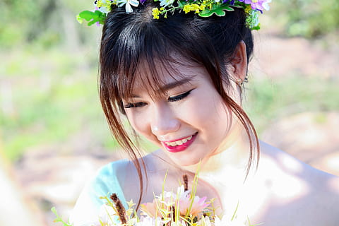 selective focus photography of smiling woman wearing flower headdress HD wallpaper