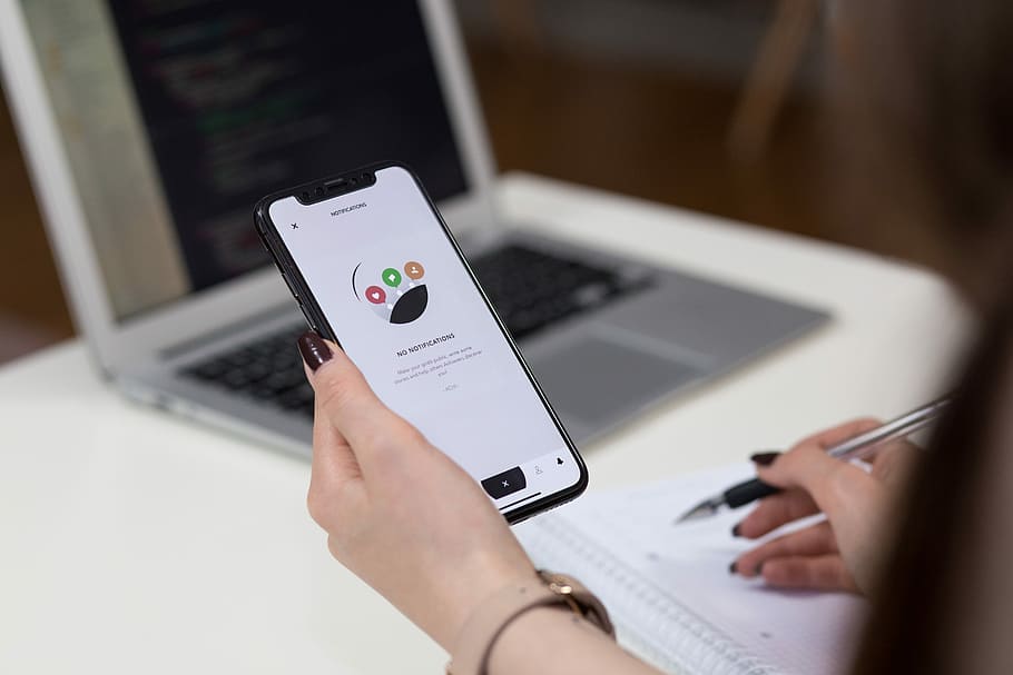 person holding space grey iPhone X turn on, person holding space gray iPhone X and ballpoint pen HD wallpaper