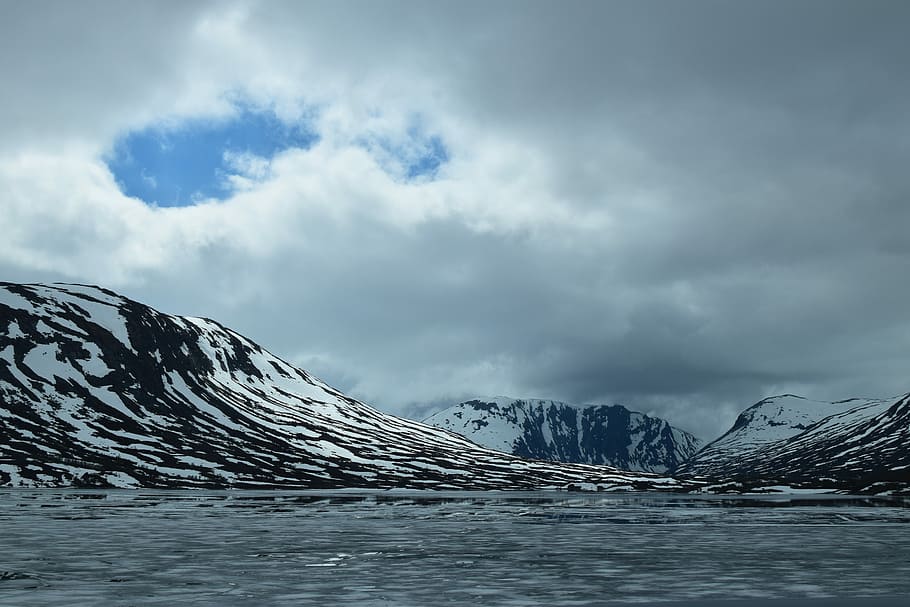 landscape photo of white and black mountain near body of water at daytime HD wallpaper