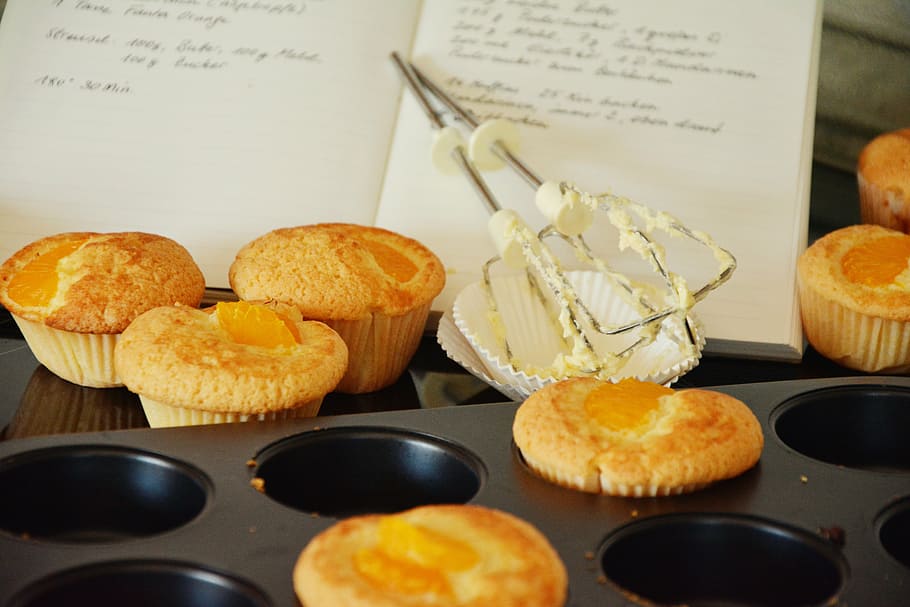 cupcakes beside book and muffin tin, muffins, bake, small cakes HD wallpaper