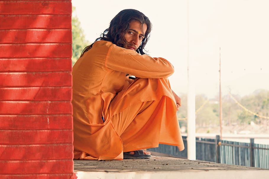man in orange long-sleeved traditional dress, wall, portrait HD wallpaper