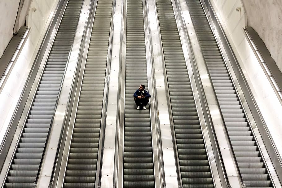 man sitting on escalator, steps, staircase, one person, indoors HD wallpaper