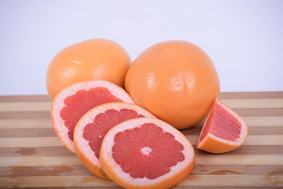 sliced orange citrus on brown wooden chopping board, grapefruit, HD wallpaper
