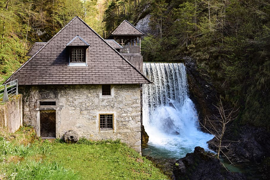 time lapse photography of plunge waterfalls near 2-storey house HD wallpaper