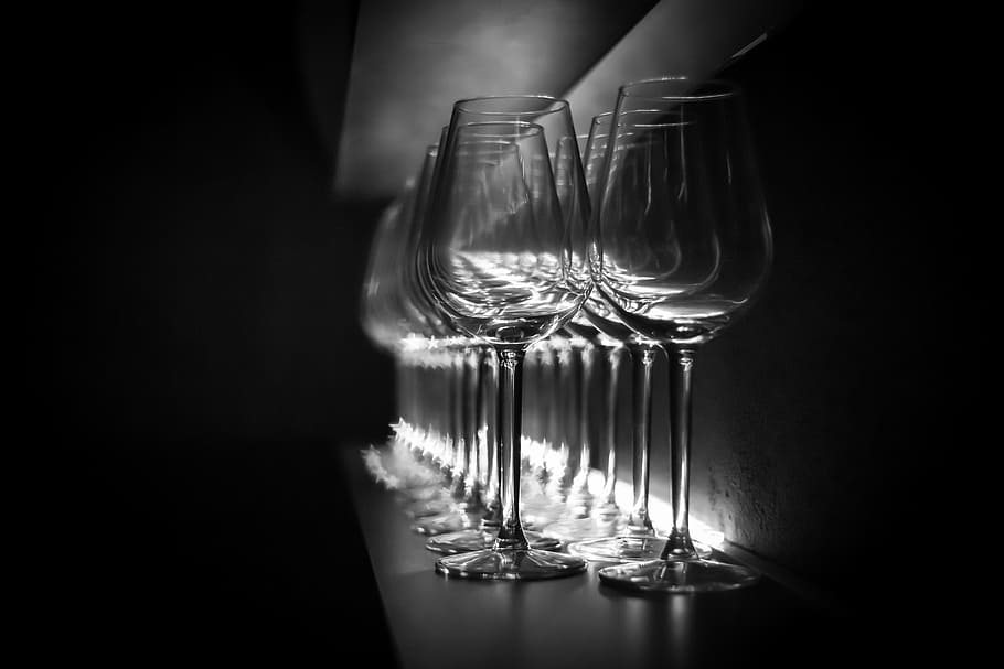 clear wine glasses on display, bar, dark, by looking, perspective