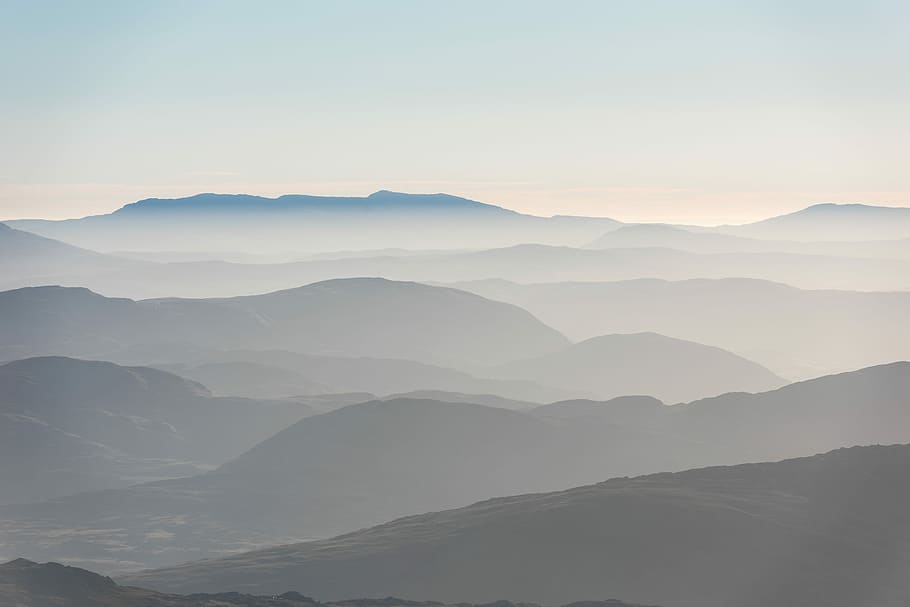 mountains cover by fogs, silhouette of mountains with fogs under white sky at daytime HD wallpaper