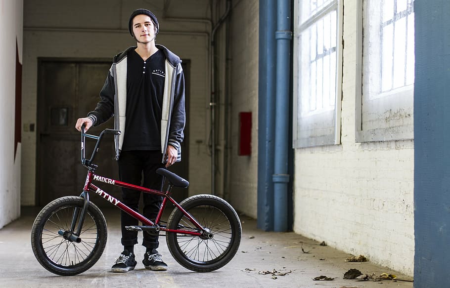 man holding BMX bike, bikes, guy, hallway, person, bicycle HD wallpaper