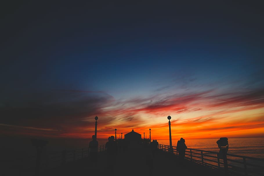silhouette of people standing on dock during golden hour, bridge HD wallpaper