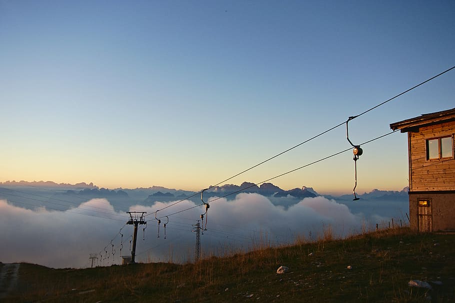 person showing hanging ride on cart, sunset, fog, mountains, nature HD wallpaper