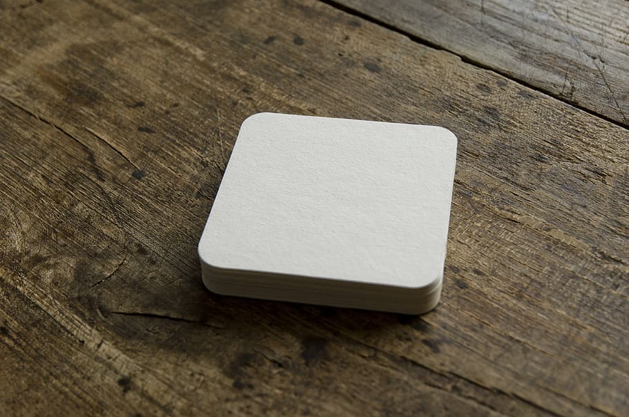 square white card on brown wooden board, beer coasters, blank HD wallpaper