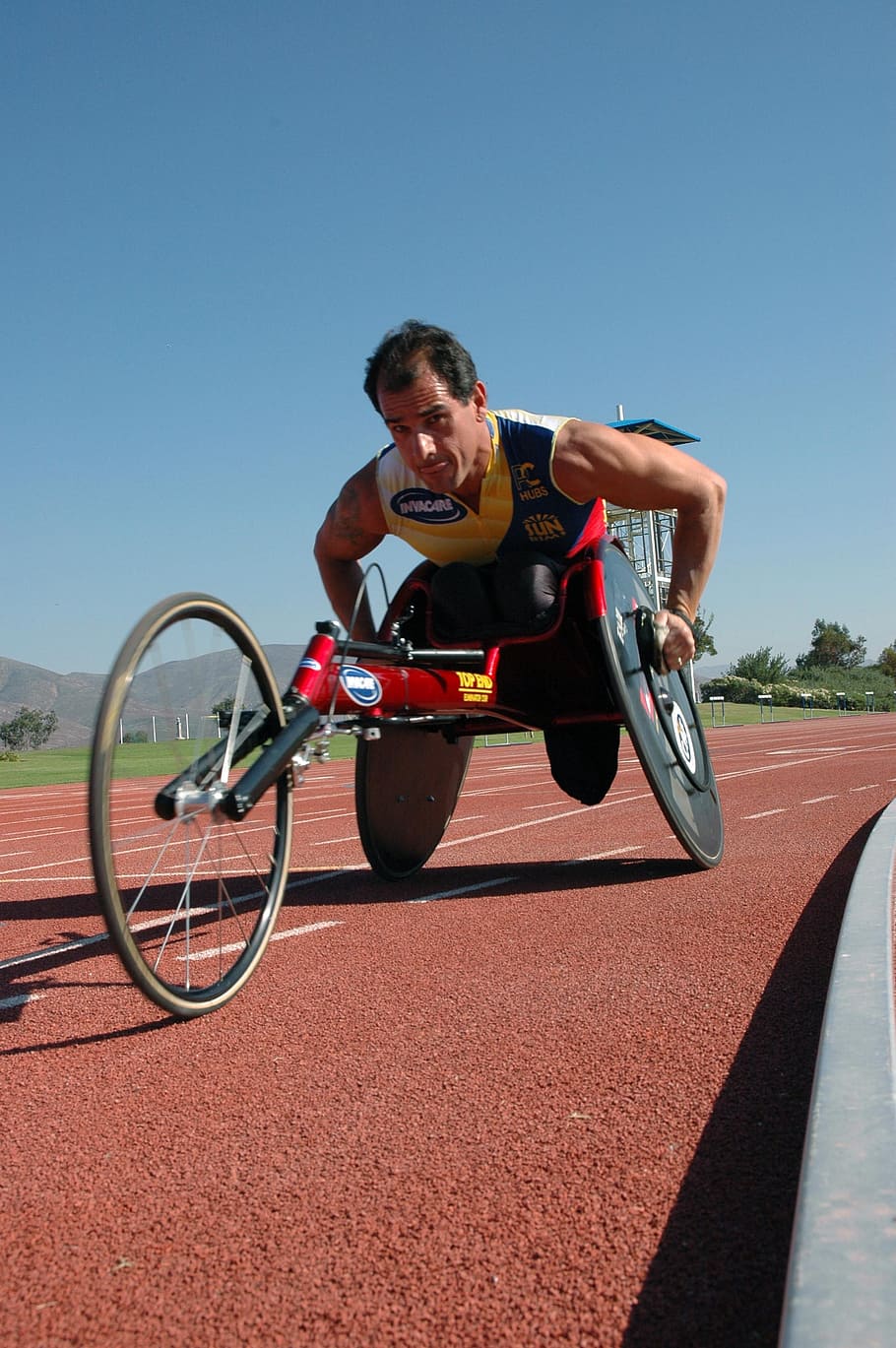 man riding on recumbent trike during daytime, athletic, disability