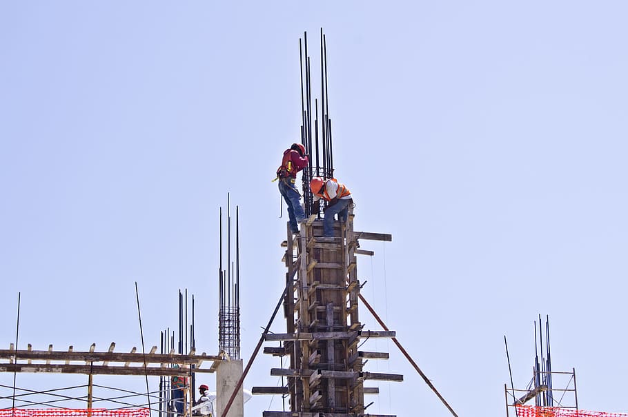 two men filling cement in building's post during daytime, workers HD wallpaper