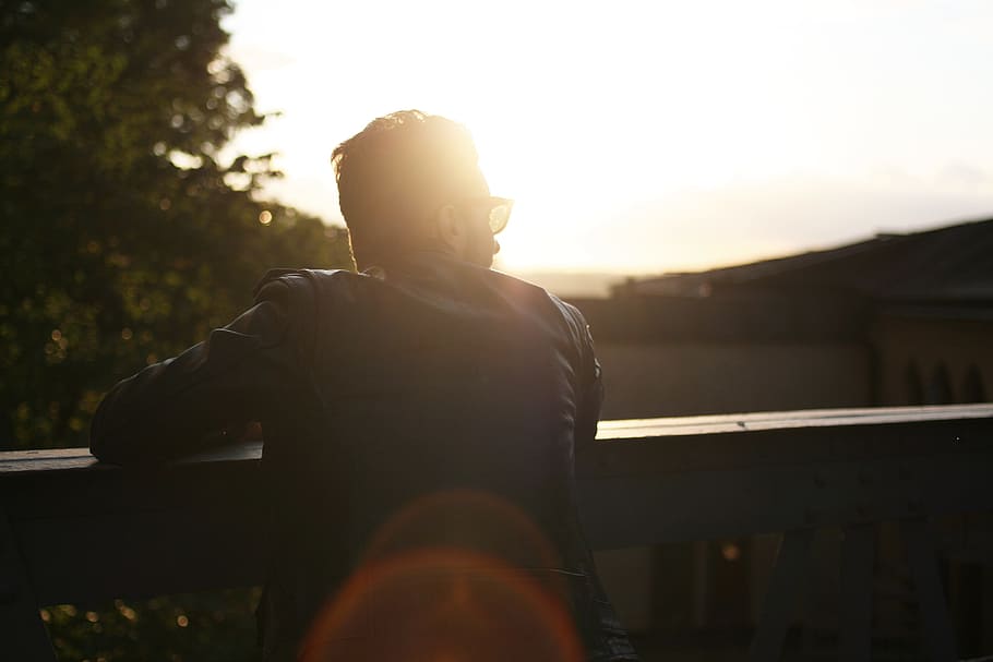 silhouette photography of person at ledge, man wearing black suit during sunset HD wallpaper
