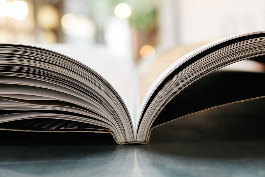 bokeh photography of open book, shallow focus photography of white book HD wallpaper
