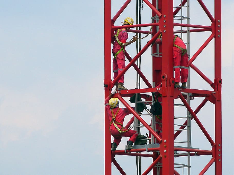 three people in red coveralls on top of tower, construction HD wallpaper