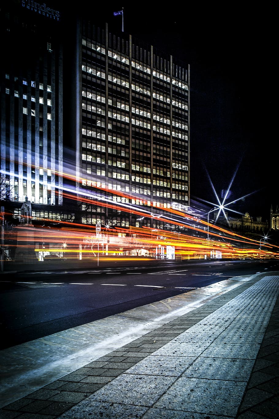 Light trails over urban road, time lapse photography of lighted building HD wallpaper