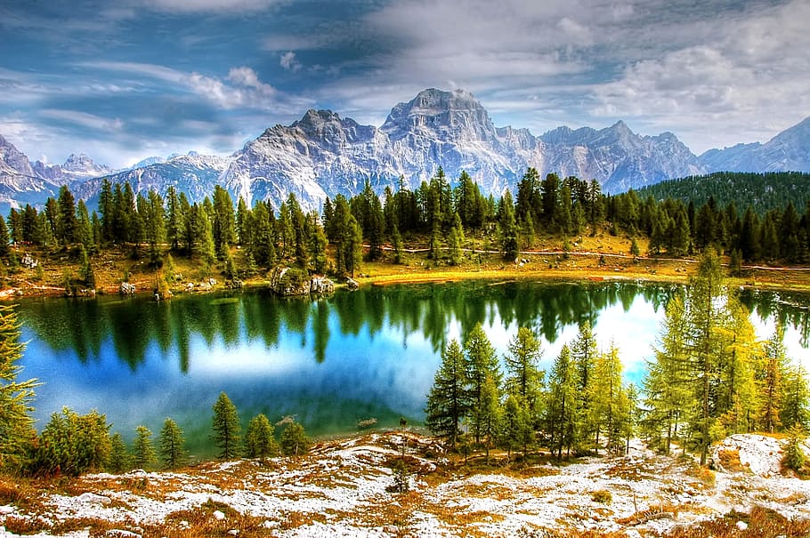 photo of body of water near forest during daytime, dolomites