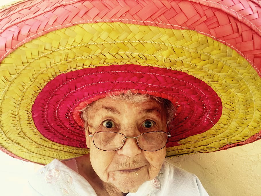 woman in pink and yellow stripe straw sun hat close up photo HD wallpaper