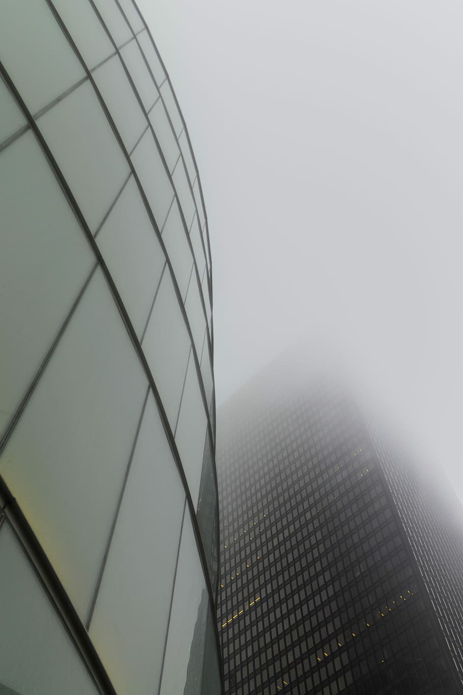 glass building under white sky during daytime, low angle photography of building HD wallpaper